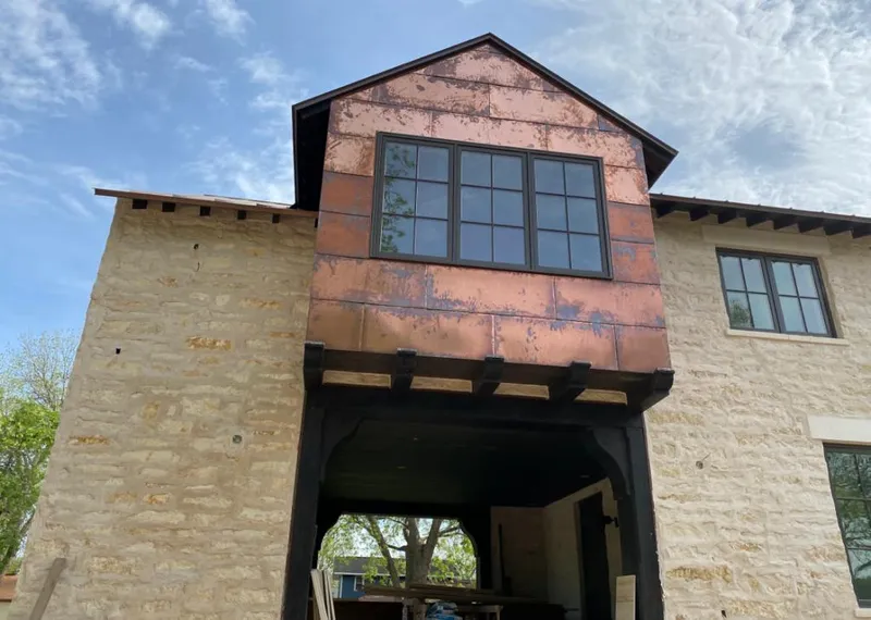 Copper metal panel facade on a stone building for Skylight Installation in Helotes
