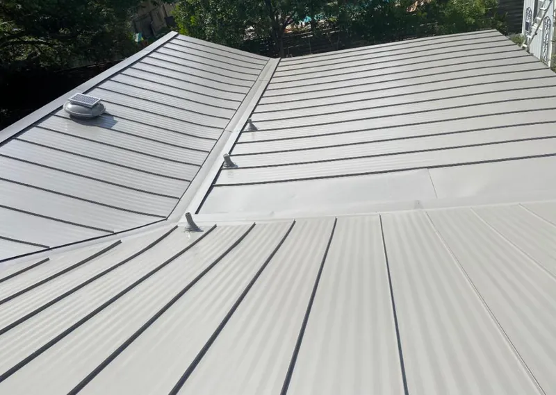 Solar attic fan installed on a metal roof for Roof Ventilation in Helotes